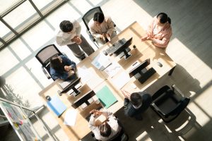 Business team standing around a conference table during meetings
